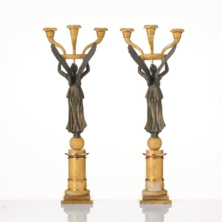 A pair of Empire ormolu and patinated bronze three-branch candelabra, possibly by R. F. Lindroth (1813-17).