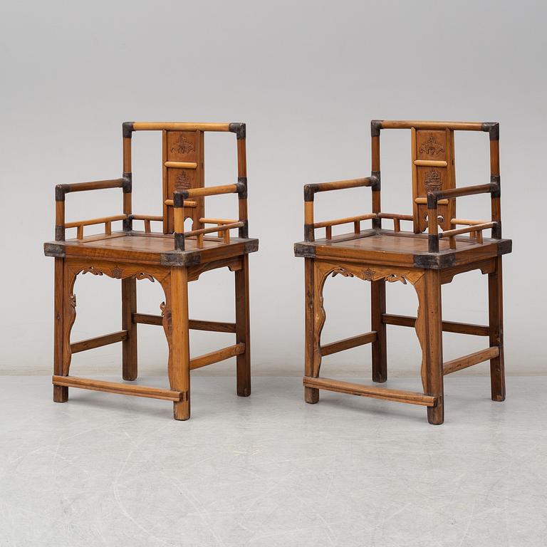 A pair of Chinese wooden armchairs, late 19th/early 20th century.