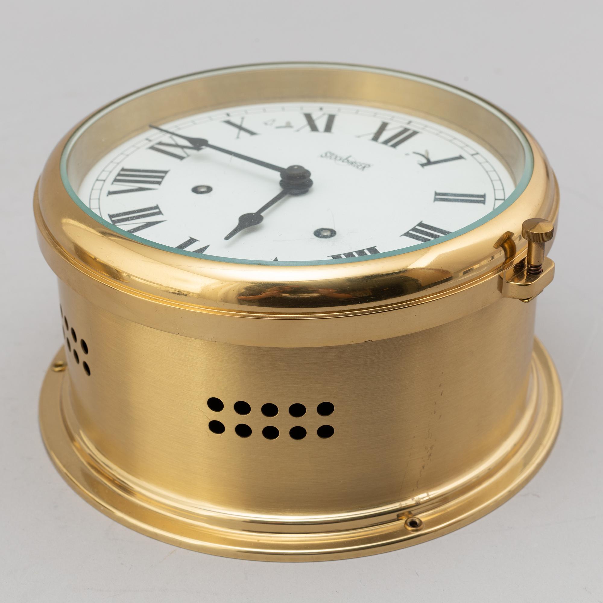 A BRASS MARINE CLOCK AND BAROMETER BY STOCKBURGER.