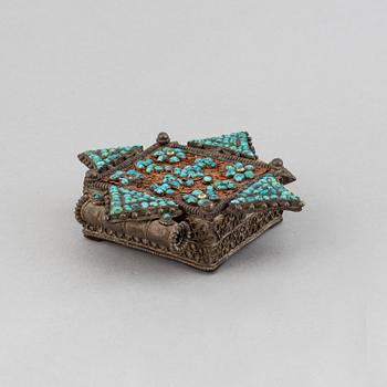 Two metal pendants with turkoise inlay, Tibet, circa 1900.