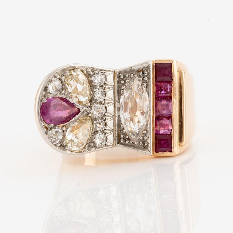 An 18K gold and platinum ring set with rubies and old-cut diamonds.