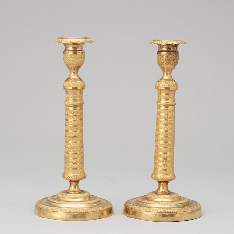 A pair of French Empire early 19th century candlesticks.