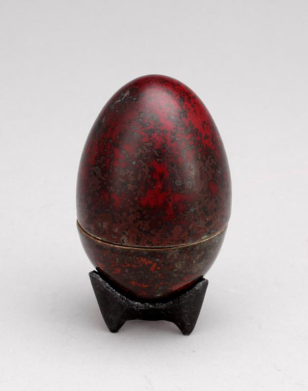 A Hans Hedberg faience egg on an iron base, Biot, France.