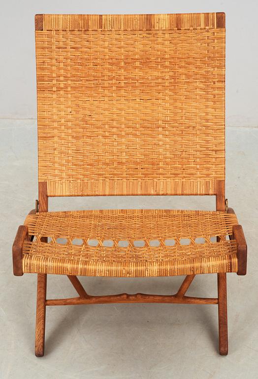 A Hans J Wegner oak and rattan folding chair, by Johannes Hansen, Denmark.