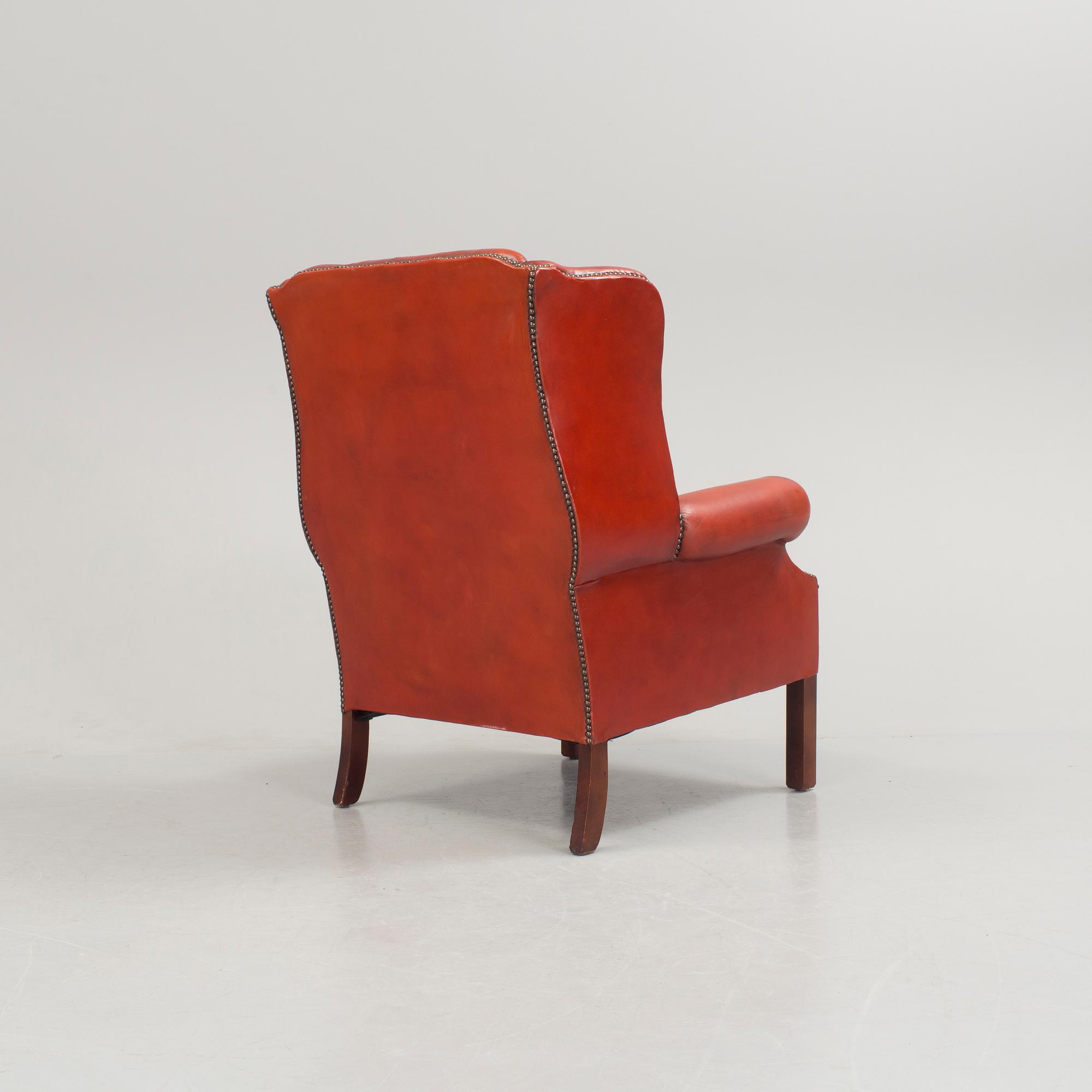 a 20h Century red lether armchair.