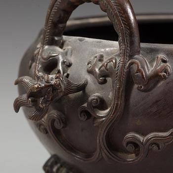 A bronze tripod censer with cover and stand, Qing dynasty, 17/18th Century.