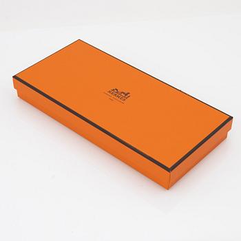 Hermès, a pair of orange kidskin and lambskin gloves, french size 8.