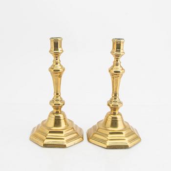 A pair of 18th century brass candle sticks.