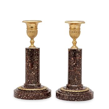 556. A pair of late Gustavian circa 1800 porphyry and gilt bronze candlesticks.