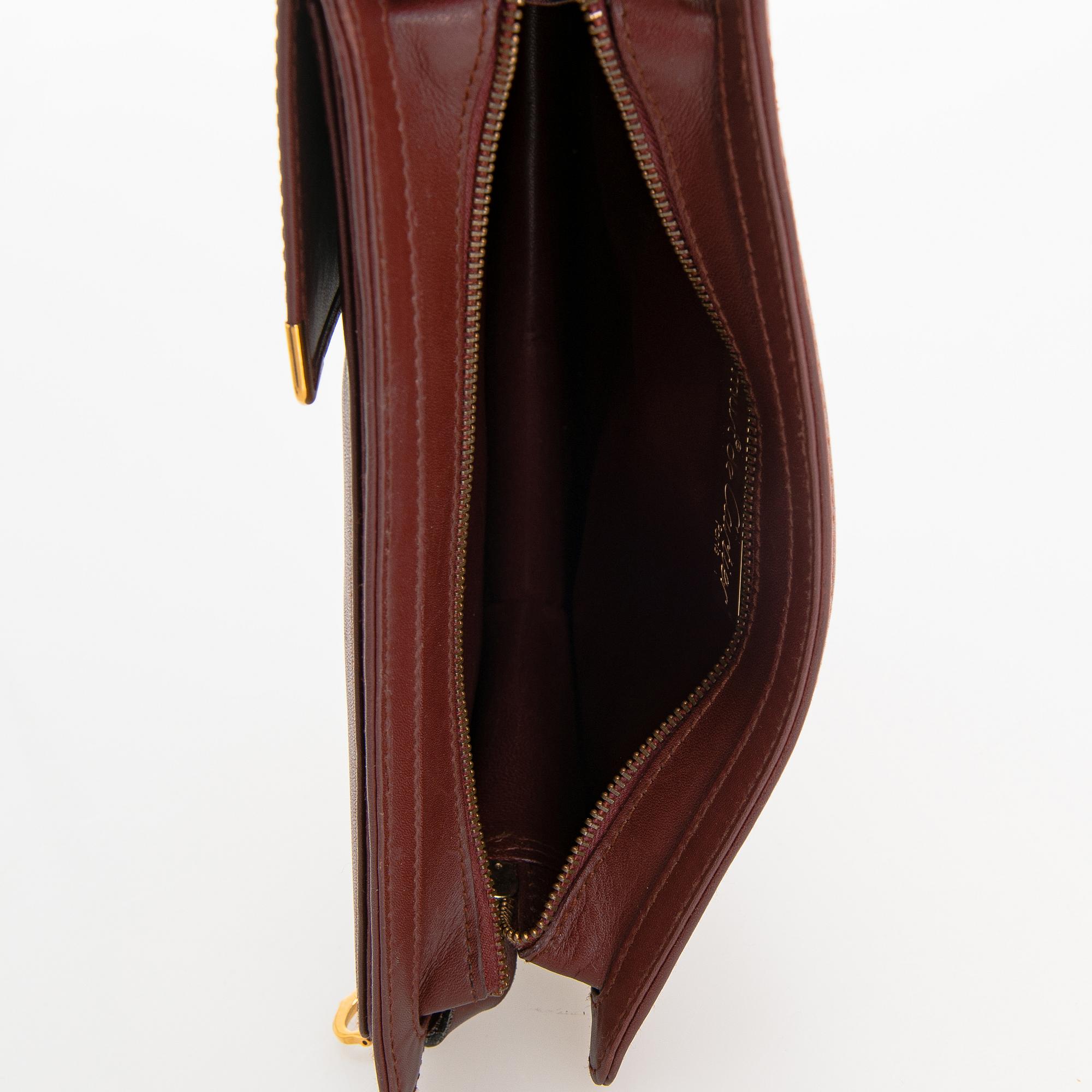 Must de Cartier bag clutch with accessories.