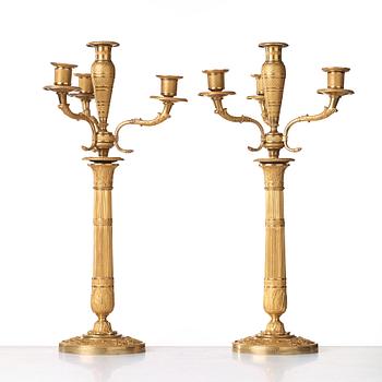 A pair of Empire early 19th century gilt bronze four-light candelabra.