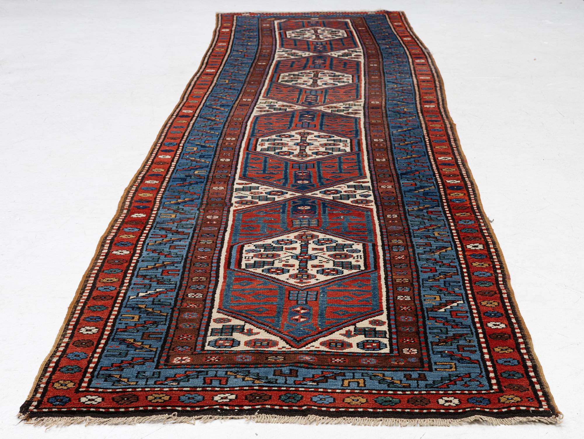 An antique Kurdish runner, probably,. 406 x 105 cm.
