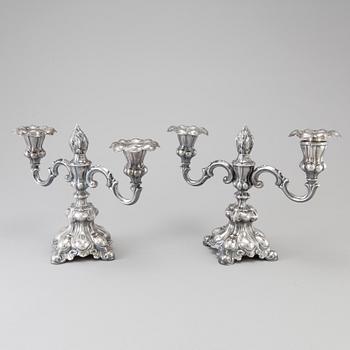 A pair of Swedish Rococo style silver candelabras from C G Hallberg in Stockholm 1955 and 1959.