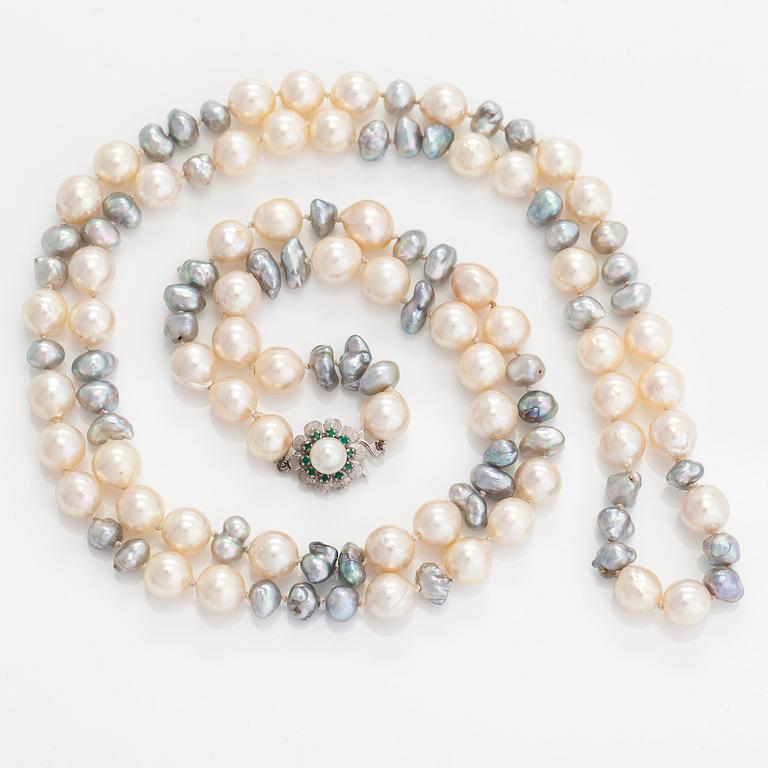 A cultured saltwater pearl necklace, clasp in 18K white gold with small emeralds.