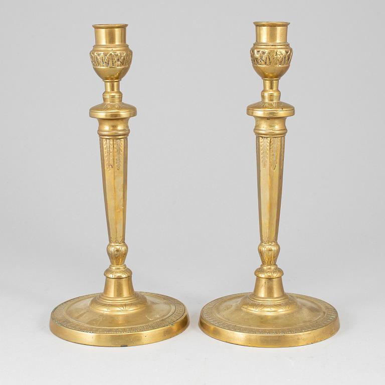 A pair of late 18th century bronze candlesticks.