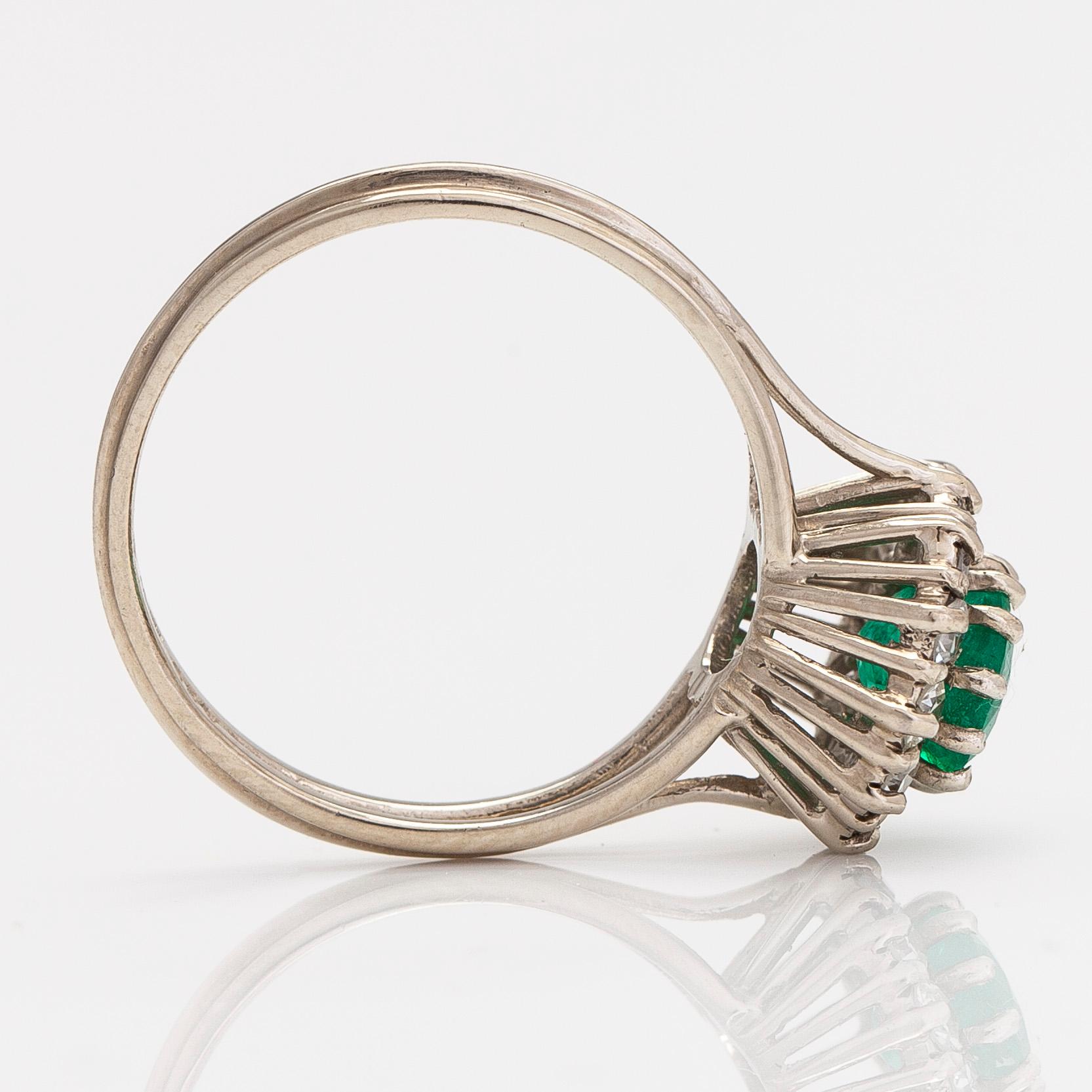 A 14K white gold ring, with an emerald and single-cut diamonds. Finnish import marks.