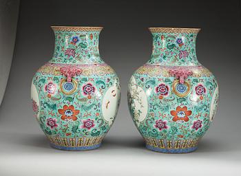 A large pair of turquoise ground famille rose vases, early 20th Century with Qianlongs sealmark.