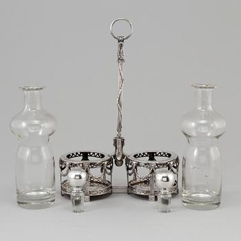 A silver bottle holder with glass bottles, possibly from Holland. From around year 1900.