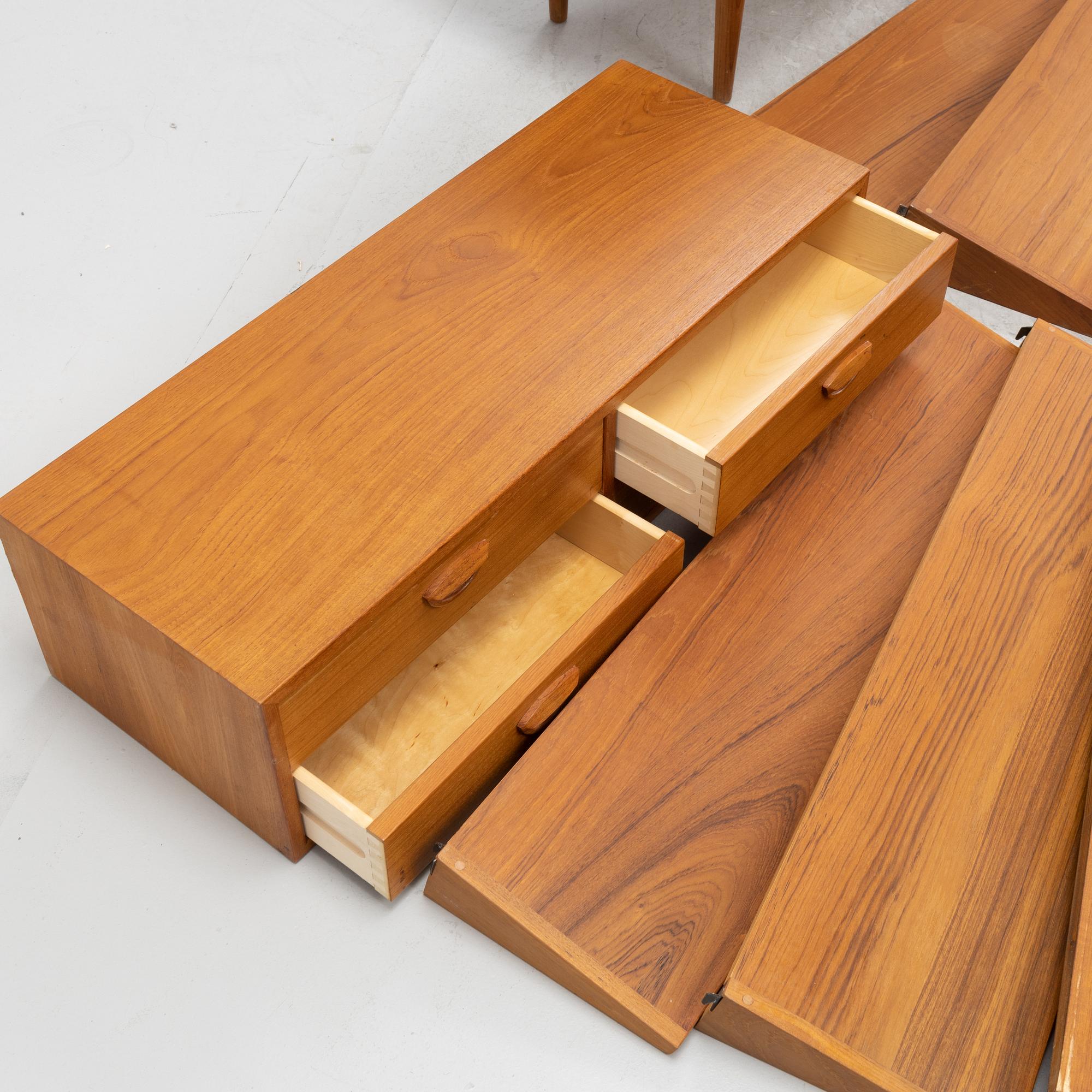 A teak and teak veneered shelf system, mid 20th century.
