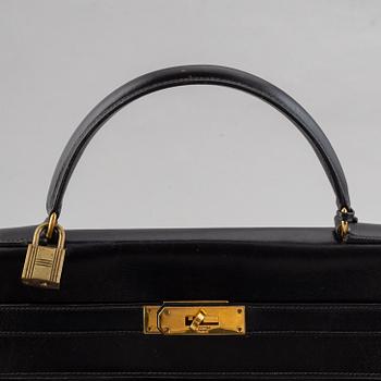 Hermès,a black leather 'Kelly 32' handbag, 1975.