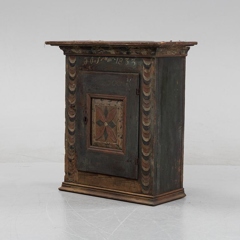 A Swedish provincial wall hanging cabinet, 1833.