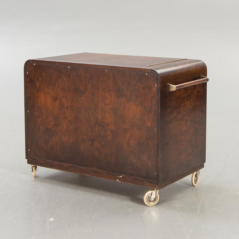 A stained birch bar cabinet from NK dated 1936.