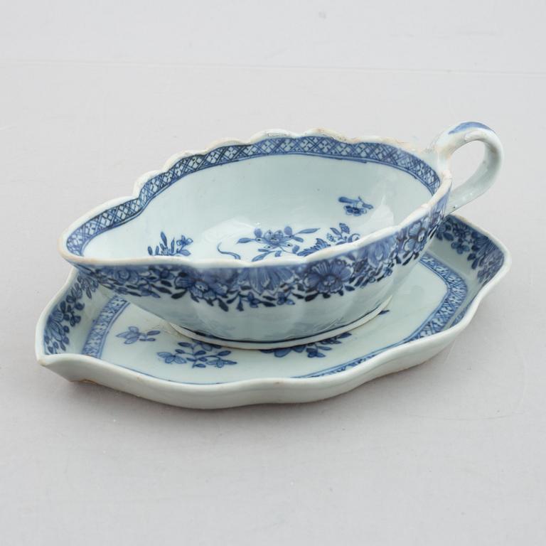 A blue and white vegetable tureen with cover and a sauce boat with a dish, Qing dynasty, 18th Century.