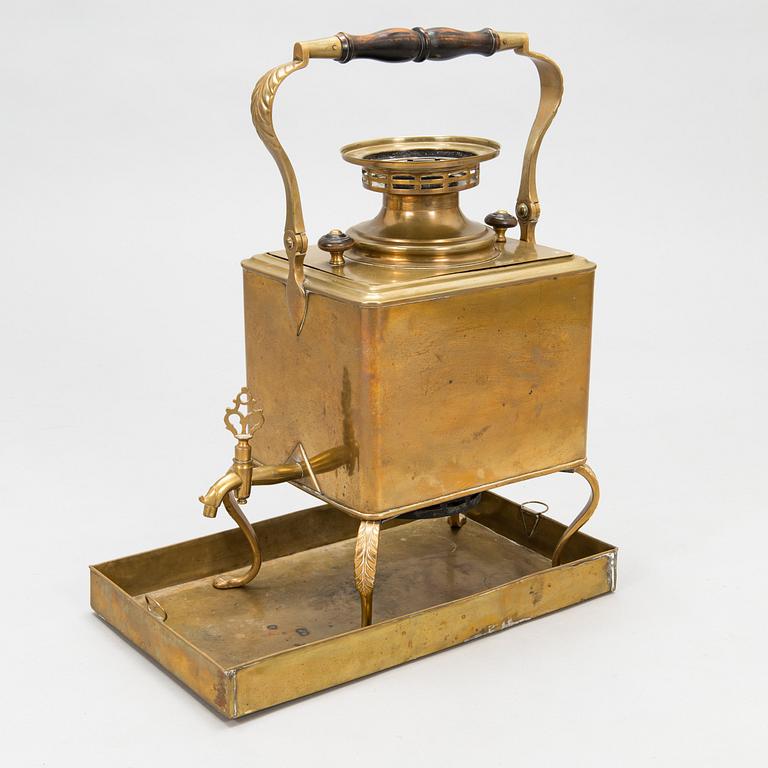 A brass samovar in a stand with a Kuznetsov porcelain teapot and bowl, latter half of the 19th century and early 1900s.