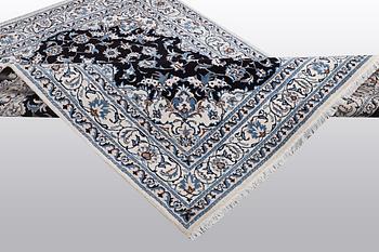A rug, Nain, part silk, ca 242 x 167 cm.