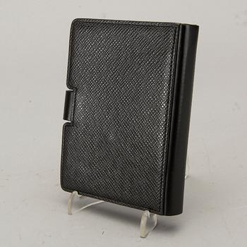 A Louis Vuitton palm pilot leather cover.