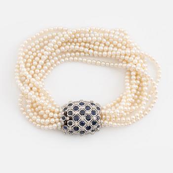 Cultured pearl bracelet, eleven strand, clasp white gold with sapphire and diamonds.