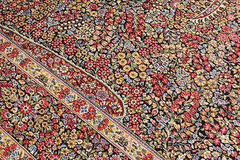 A Kirman Laver carpet, 'Millefleur', approx. 392 x 300 cm.