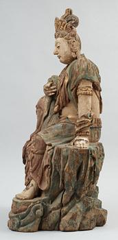 A seated wooden figure of Guanyin, presumably Ming dynasty (1368-1644).