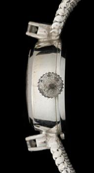 DAMARMBANDSUR, vitguld 18k, två små briljantslipade diamanter, Movado. Vikt ca 22 gram.
