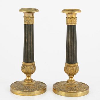 A pair of French Empire ormolu and patinated bronze candlesticks, first part of the 19th century.