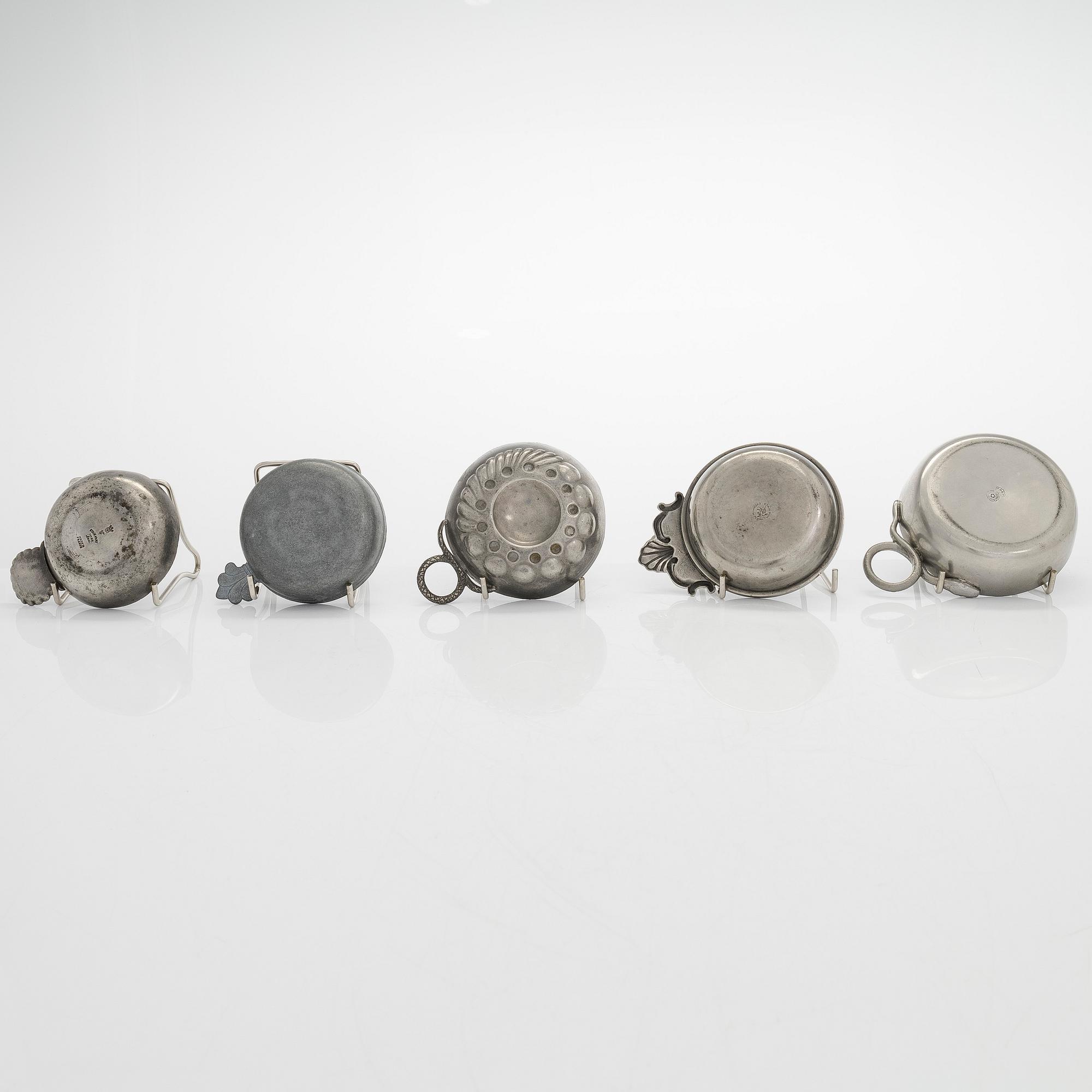 A set of fourteen tastevin cups, pewter and glass, 20th century.