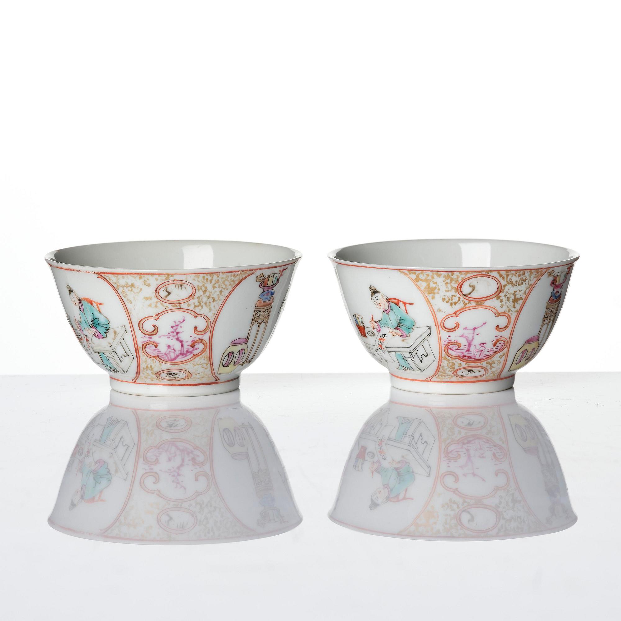 A pair of famille rose 'figural' tea cups with saucers, Qing dynasty, Qianlong (1736-95).