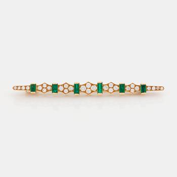 463. An 18K gold brooch set with step-cut emeralds and round brilliant-cut diamonds.