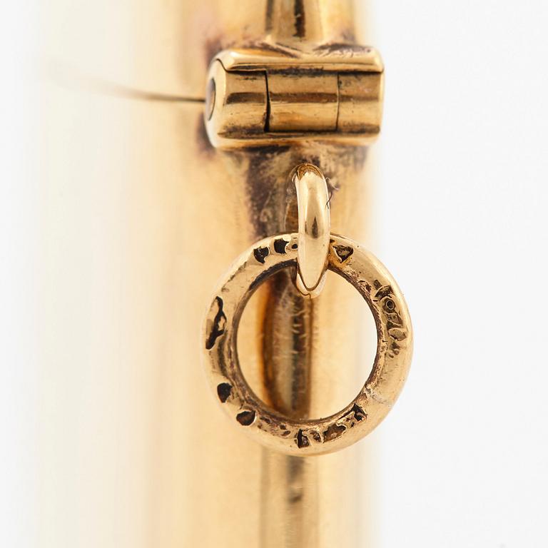 An 18K gold match case/pendant set with a faceted sapphire.