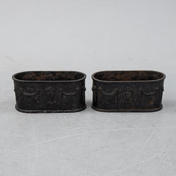 A pair of 20th century cast iron plant pots.