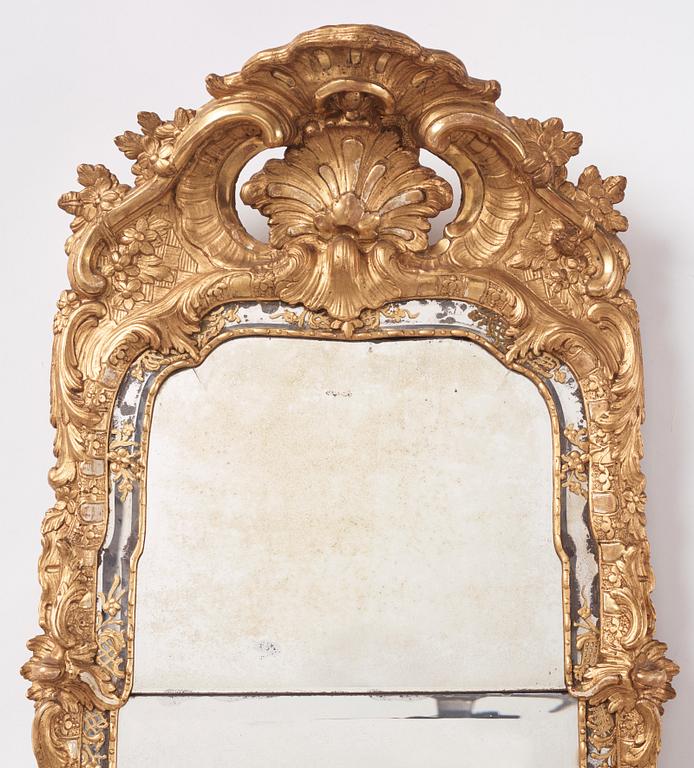 A Swedish rococo giltwood mirror, later part of the 18th century.