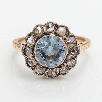A 13-14K gold ring with a synthetic spinelle and rose-cut dimaonds.