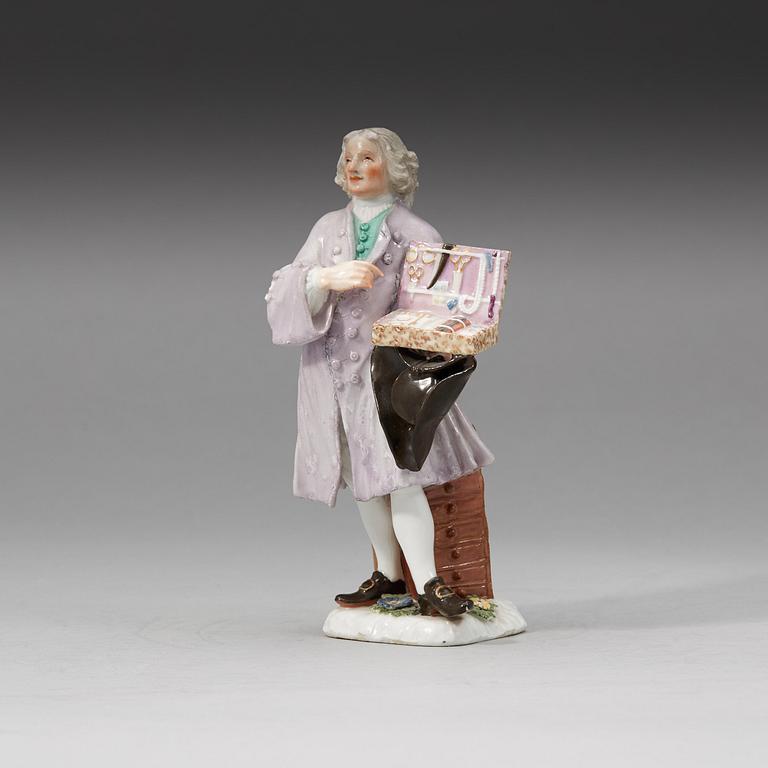 A Meissen porcelain figure of a trinket salesman from the series of Parisian street-traders, circa 1745.