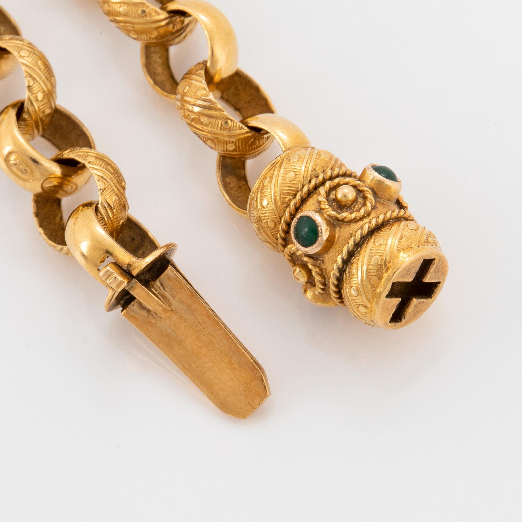 Collier 18K guld med gröna stenar.