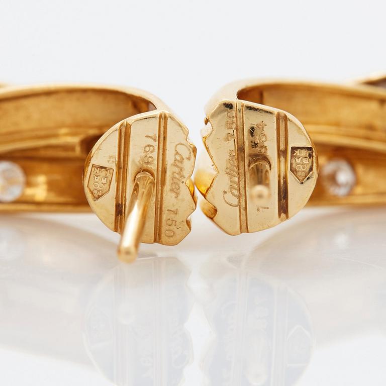 A pair of Cartier "Trinity" earrings in 18K gold set with round brilliant-cut diamonds.