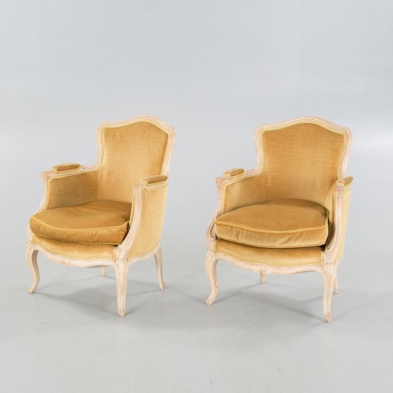 A pair of rococo style lounge chairs, first half of the 20th century.