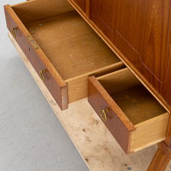 A teak-veneered mid 20th century sideboard.
