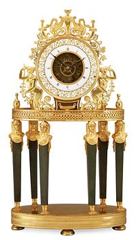 548. A French Empire gilt bronze mantel clock by L Grognot.