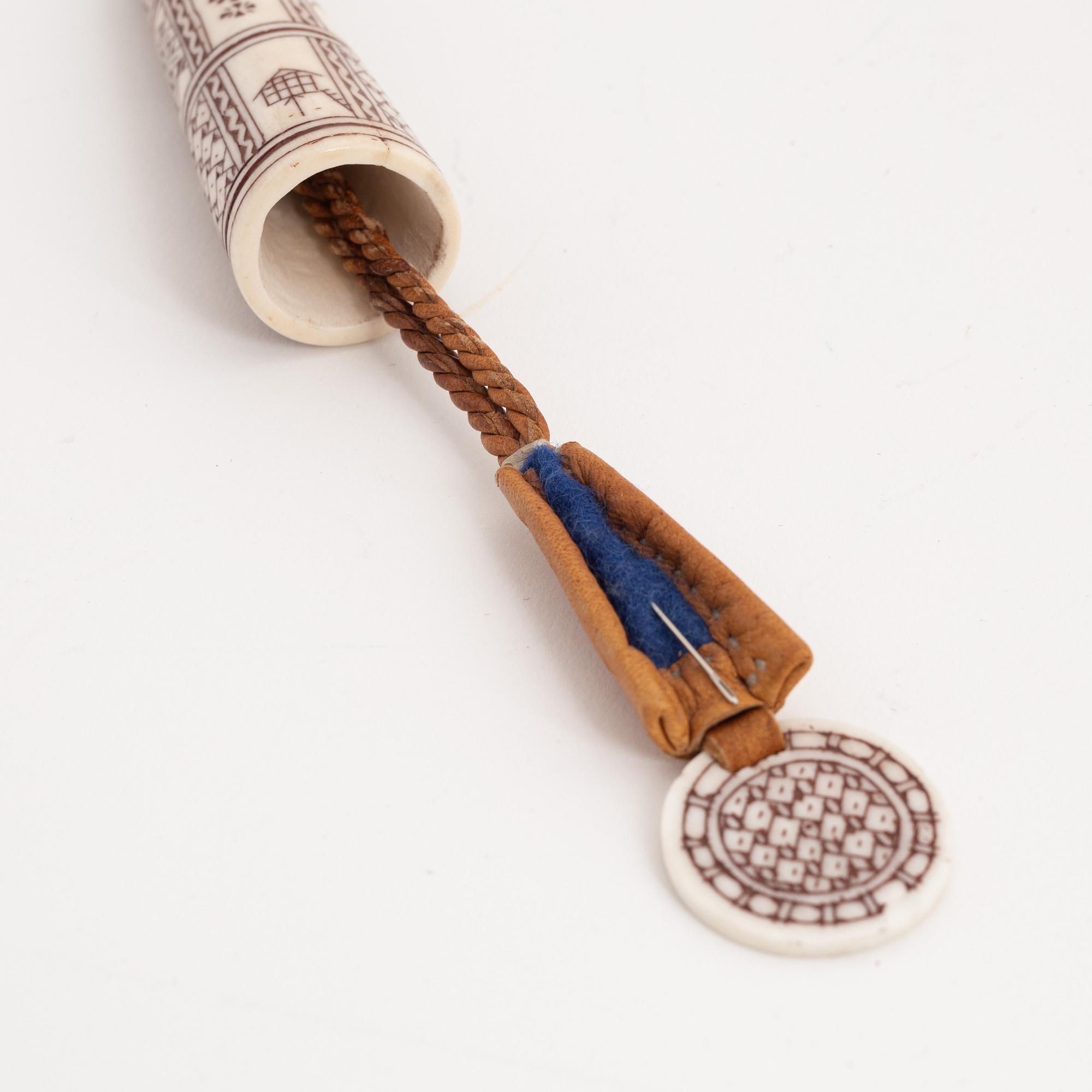 An engraved reindeer needle case.