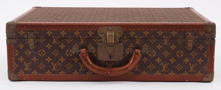 A monogram canvas suitcase by Louis Vuitton.